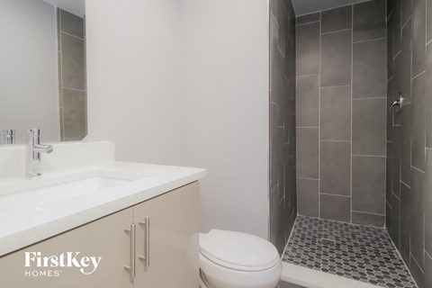 a bathroom with a toilet and a sink and a shower