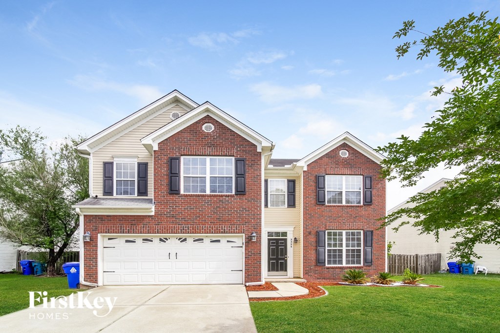 A two-story brick house with a white garage door.