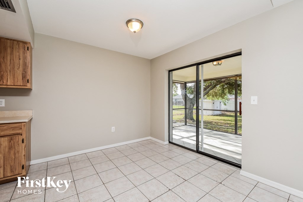 A room with a sliding glass door leading to a backyard.