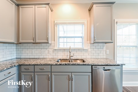 A kitchen with a sink and a dishwasher.