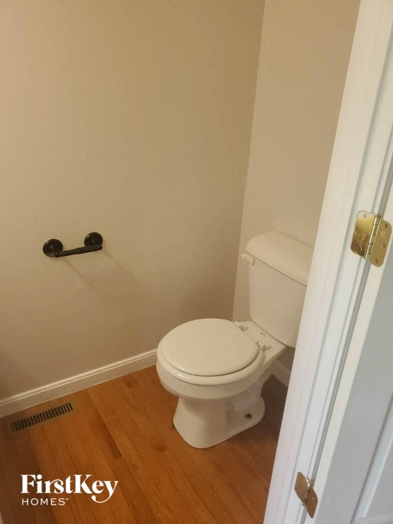 a small bathroom with a toilet and a door