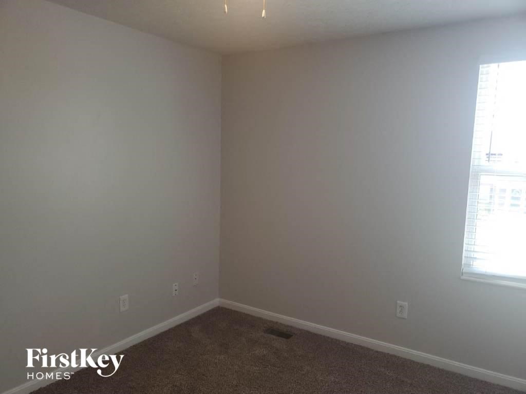 a empty room with white walls and a window