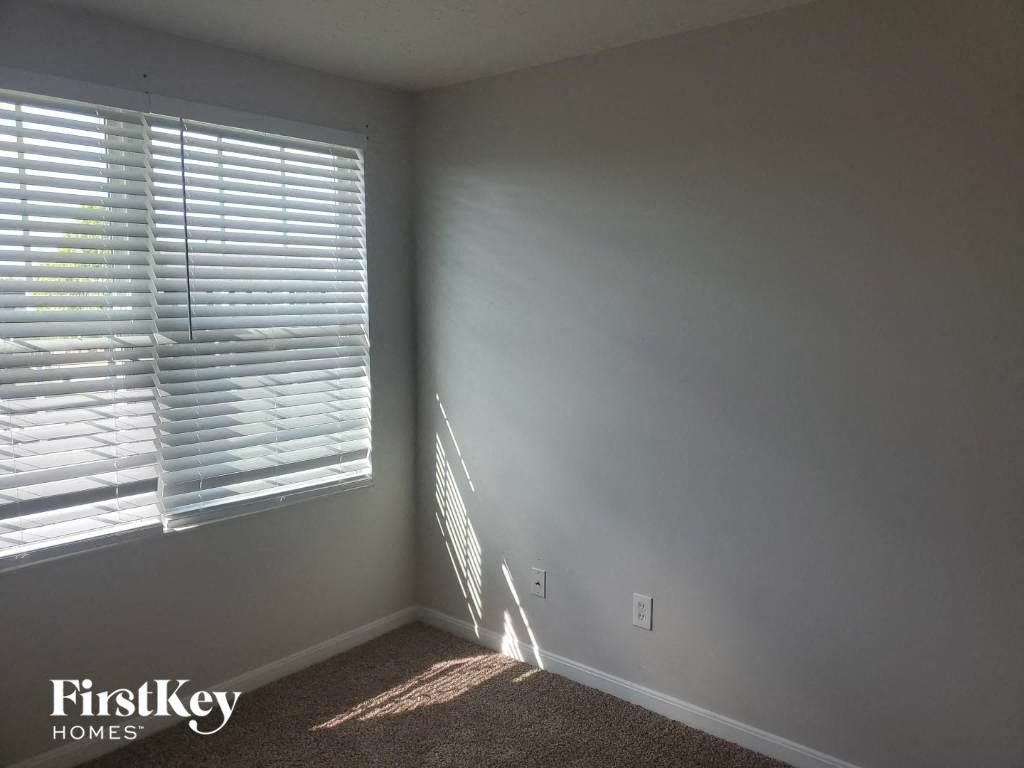 a small room with a window and gray walls