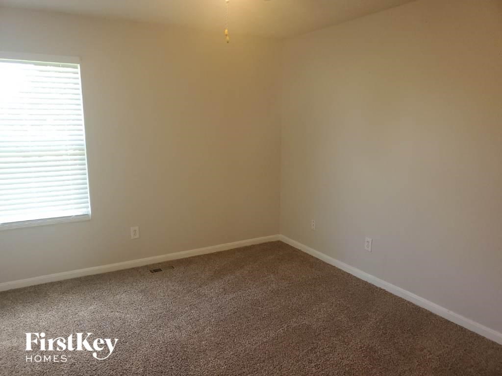 a room with a carpet and a window