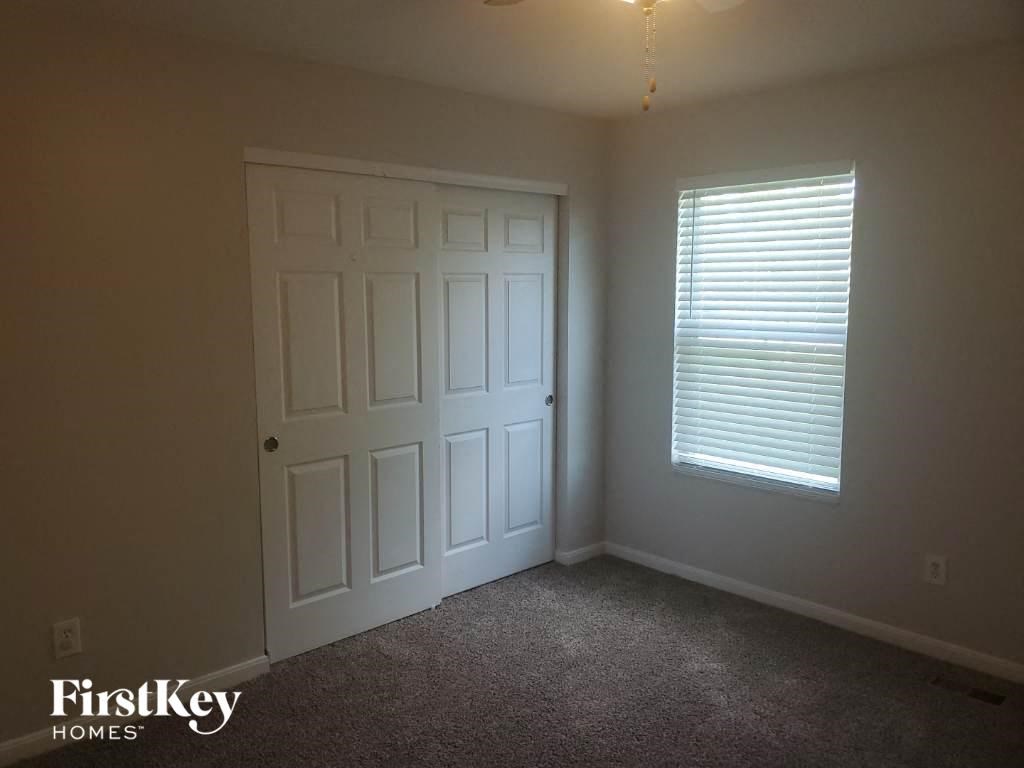 a bedroom with a white door and a window
