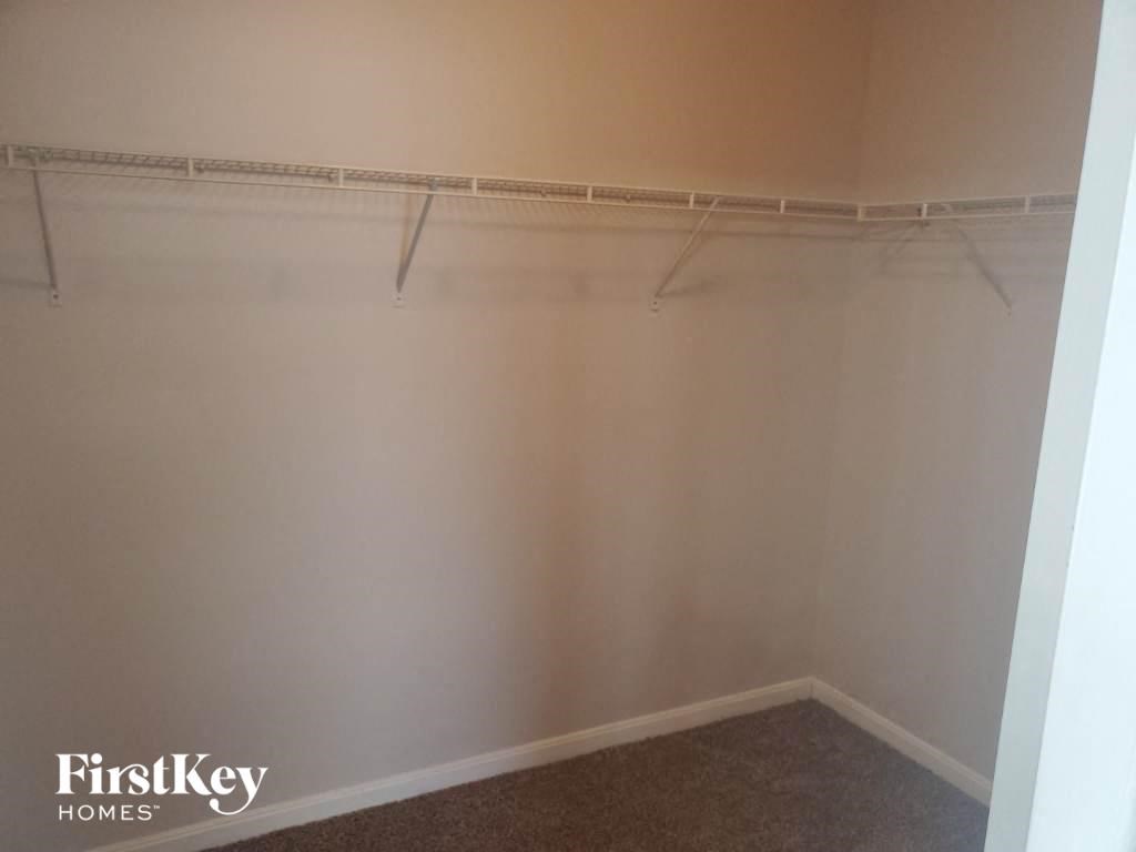 a empty closet in a room with a carpet