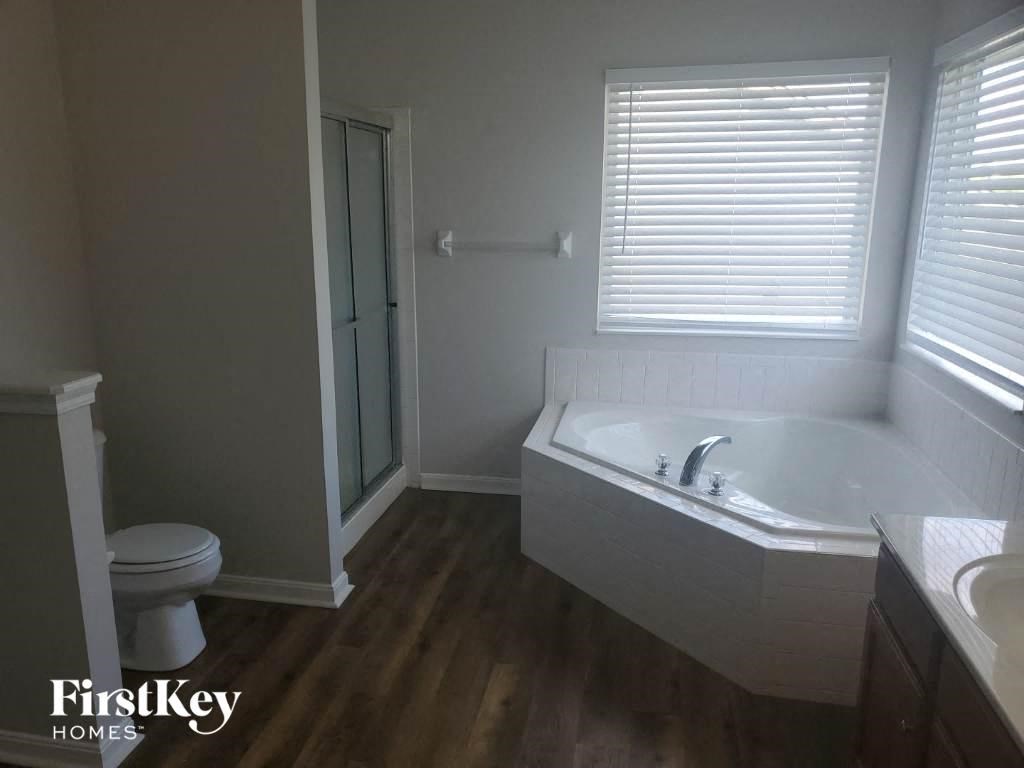 a bathroom with a tub and a toilet and a sink