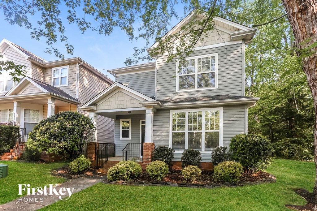 a home with a front yard and a tree