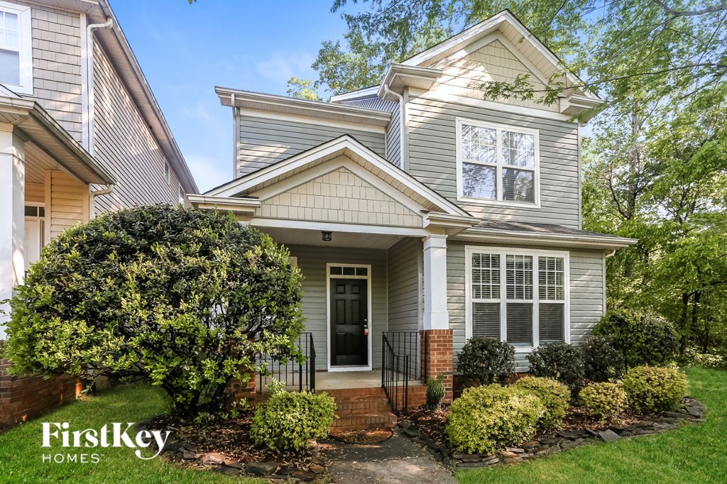 a renovated house with a front porch and a front yard