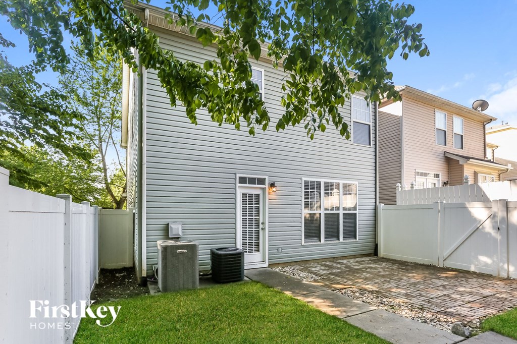 a white house with a yard and a white fence