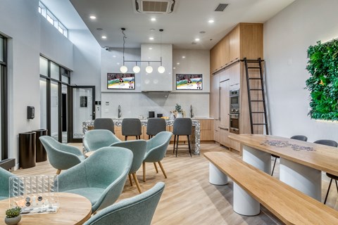 A modern office space with green chairs and a wooden table.