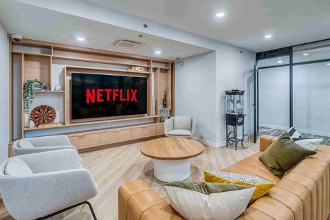 A living room with a Netflix screen on the wall.