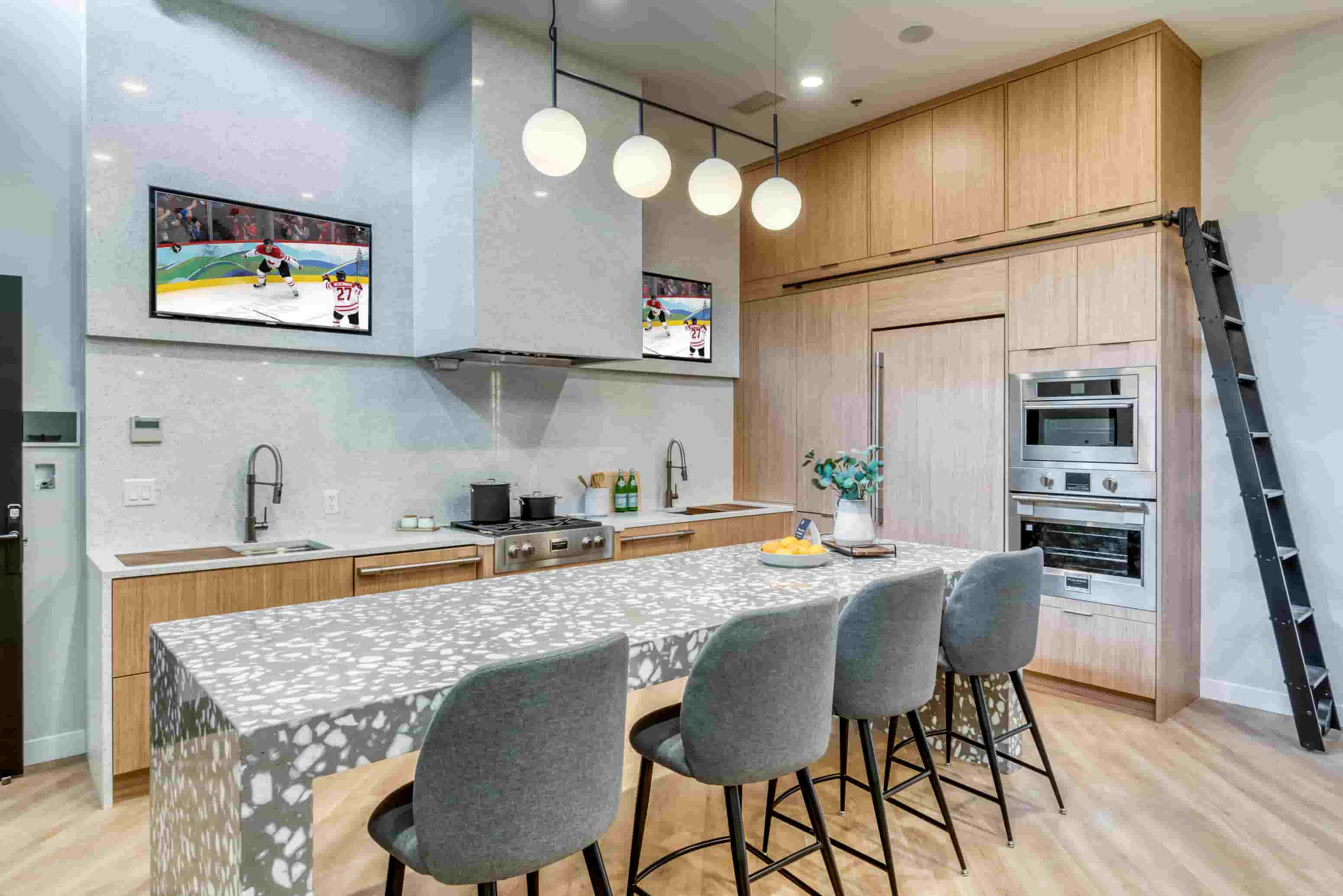 A modern kitchen with a dining table set for four.