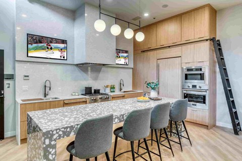 A modern kitchen with a dining table set for four.