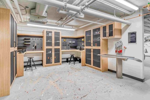 A room with a lot of woodworking equipment and a workbench.