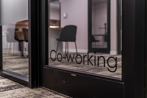 A glass door with the word "Co-working" written on it.