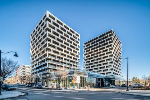 two high rise buildings on the corner of a city street