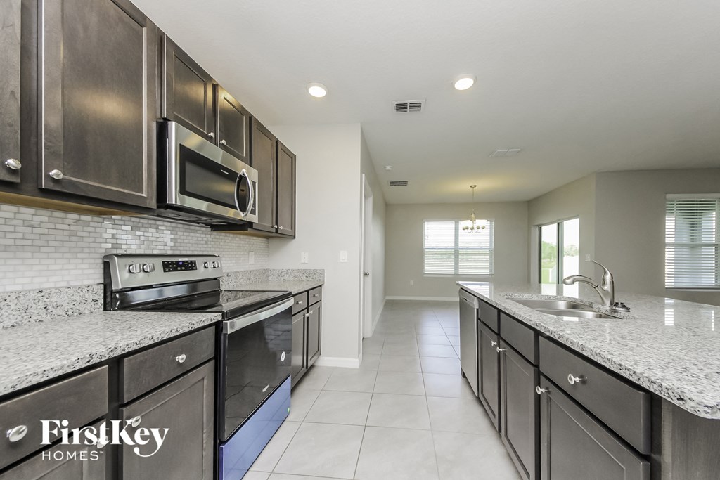 a modern kitchen with stainless steel appliances and granite counter tops