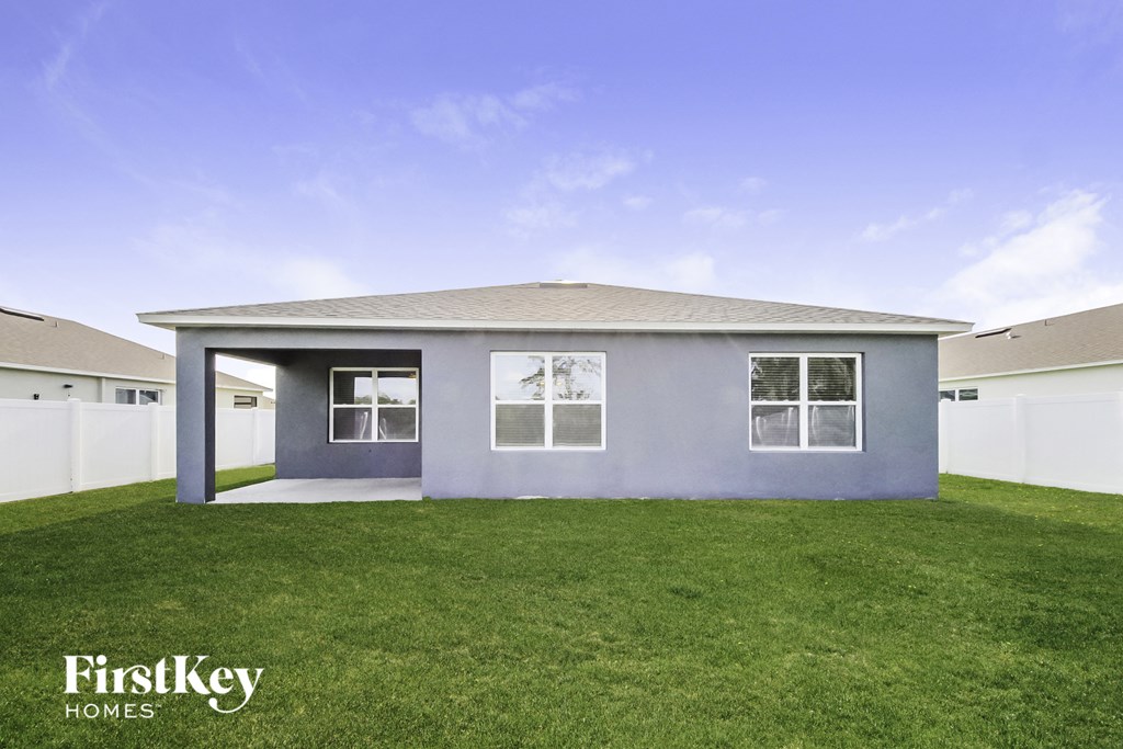 the exterior of a home with a lawn and a blue sky