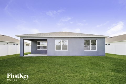 the exterior of a home with a lawn and a blue sky