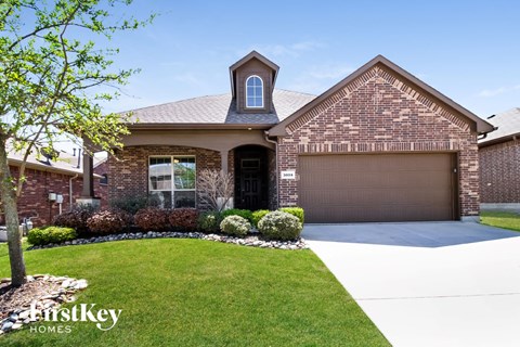 a house with a driveway and lawn in front of it