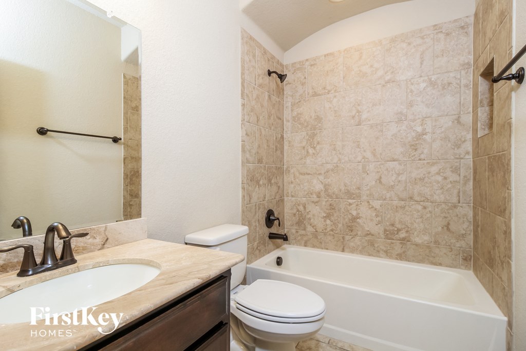 a bathroom with a sink toilet and a bath tub