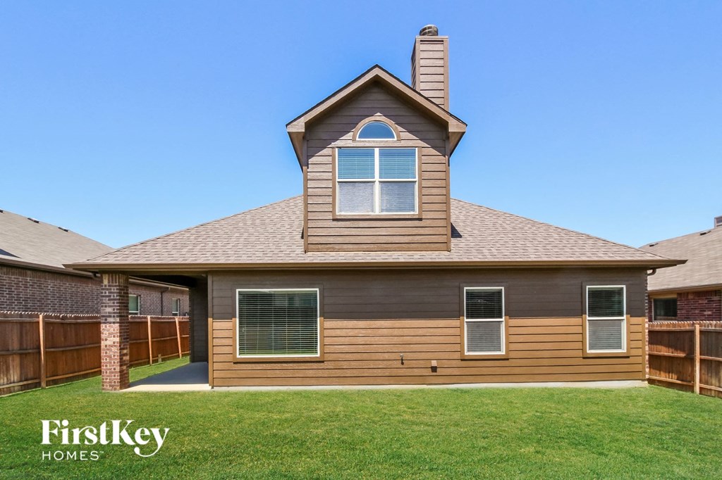 a view of a house with a fenced in yard