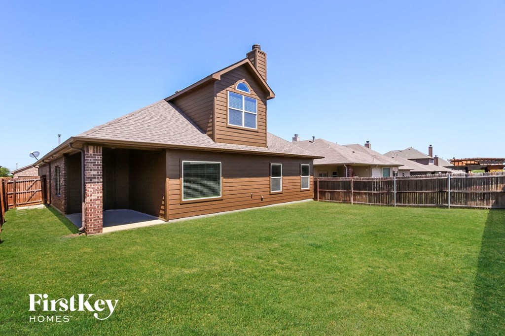 a home with a fisheye lens view of a yard and a deck