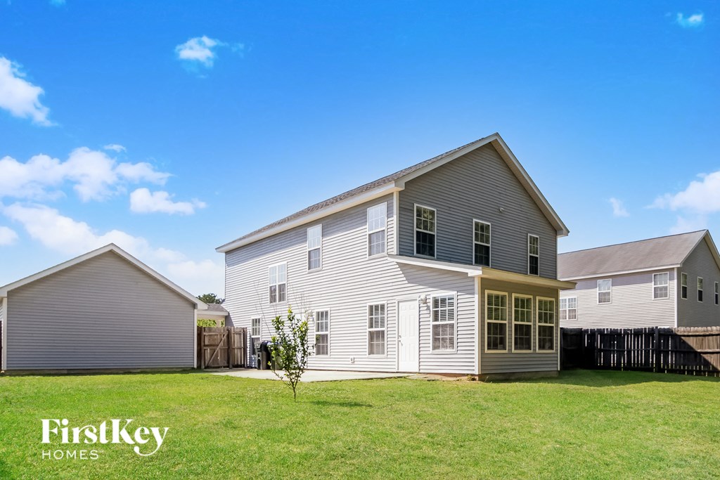 a white house with a yard and a fence