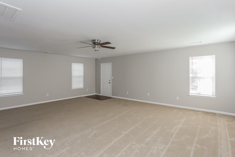 the living room of a home with a ceiling fan