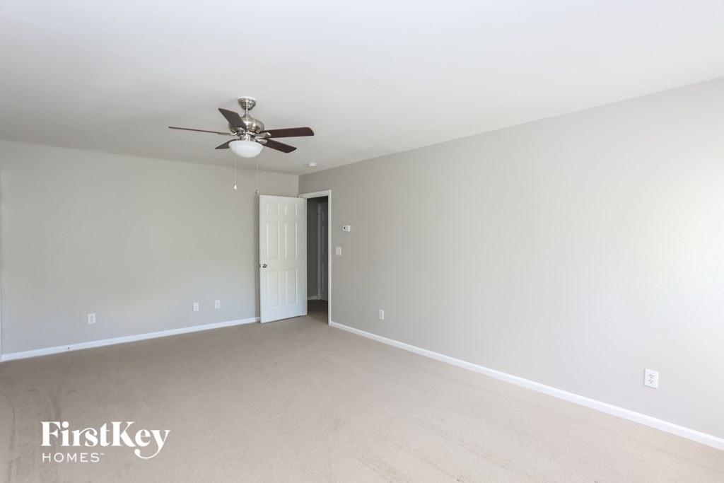 a empty living room with a ceiling fan