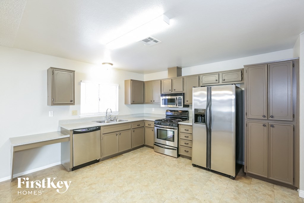 a kitchen with stainless steel appliances and stainless steel cabinets