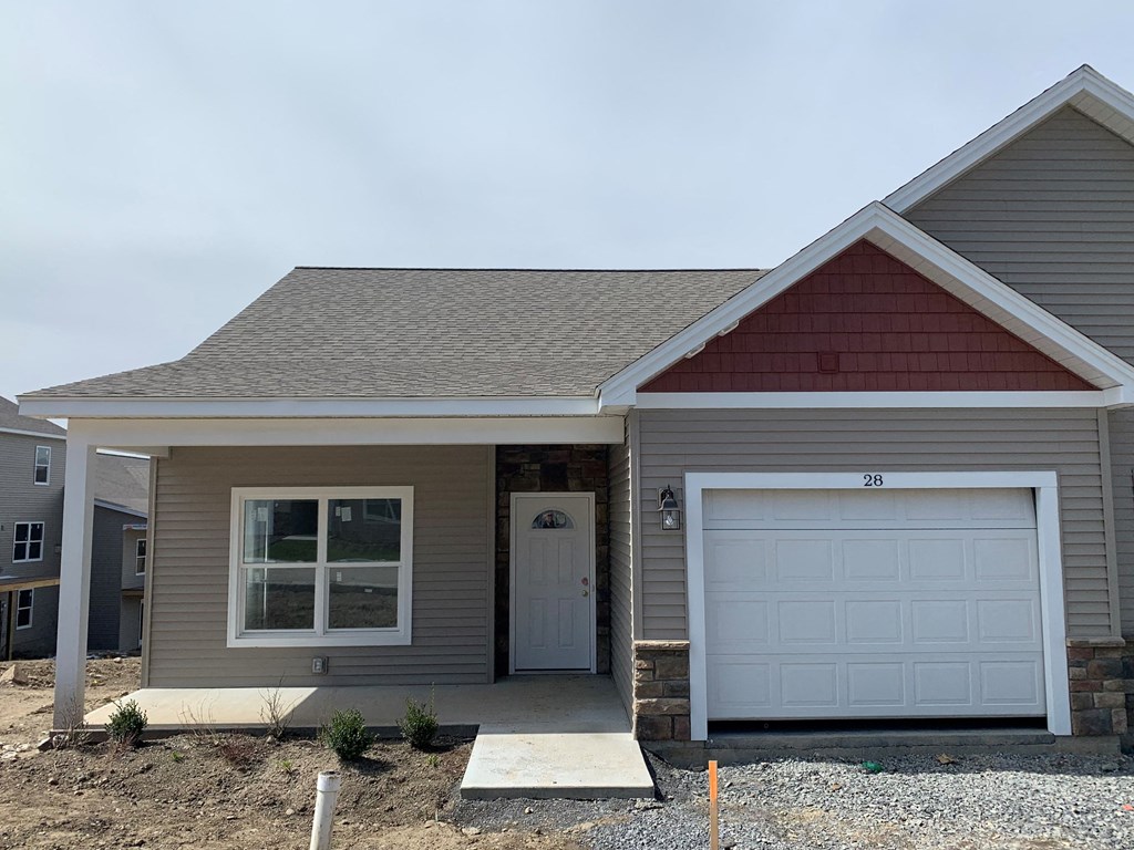 a home with a white garage door and a porch
