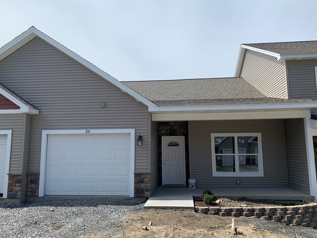 a gray house with a white garage door