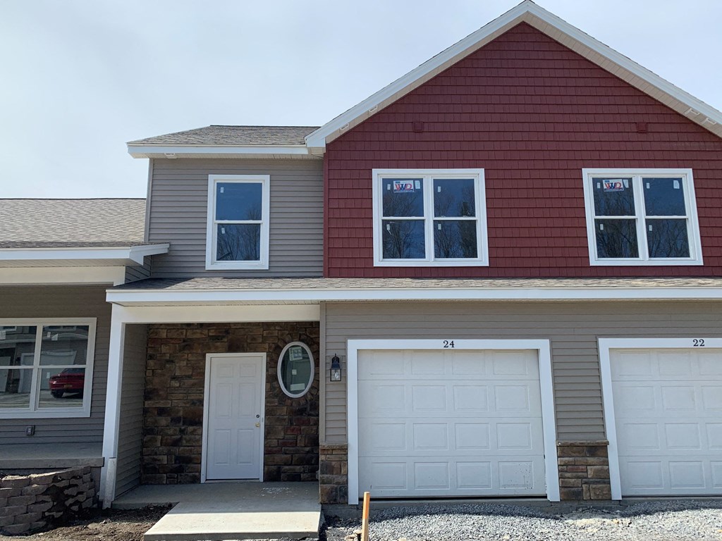 a house with two garage doors and a driveway