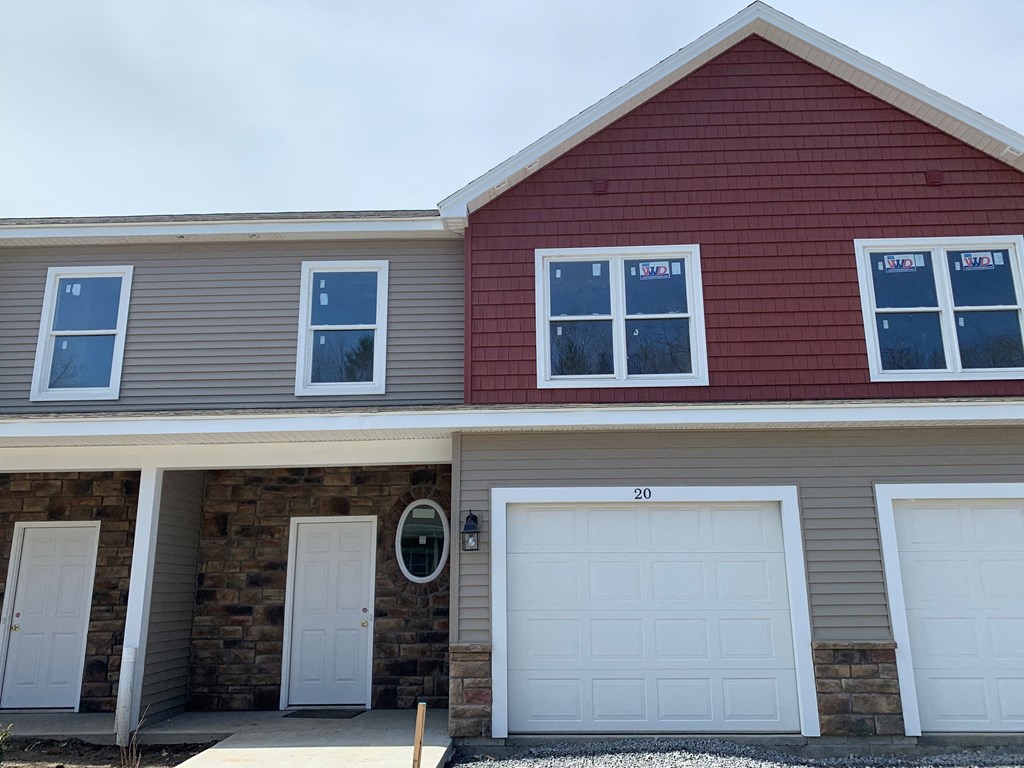 the front of a house with two garage doors