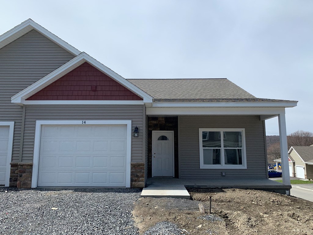 a beige house with a white garage door