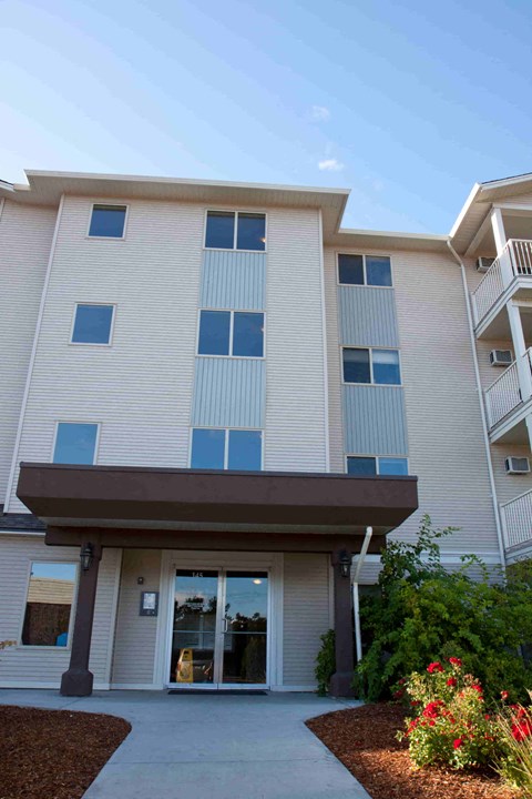 the front of a white building with a porch