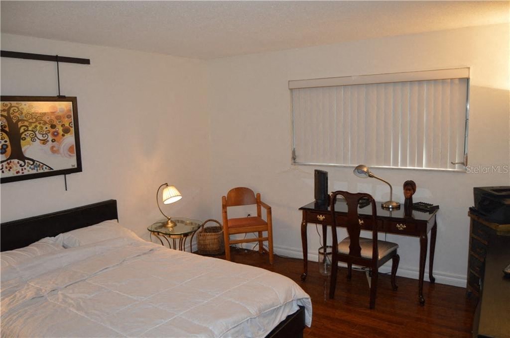 a bedroom with a bed and a desk