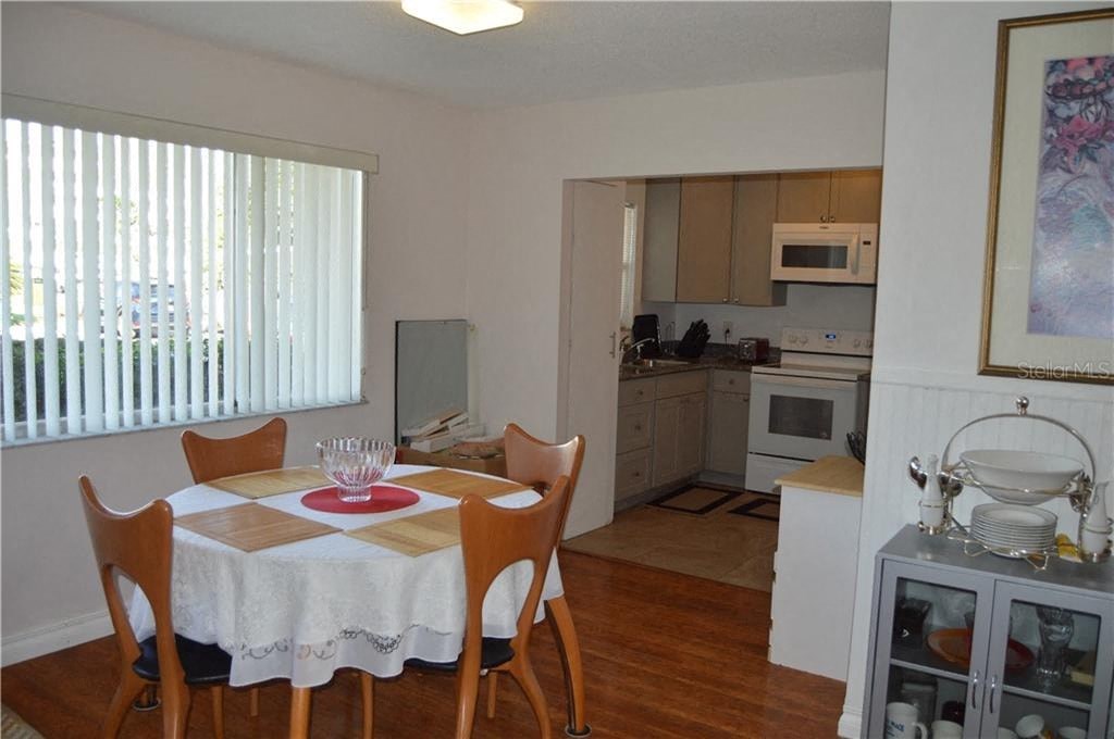 a kitchen and dining room with a table and chairs
