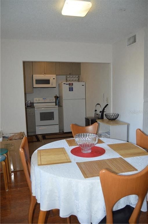 a dining room with a table and a kitchen
