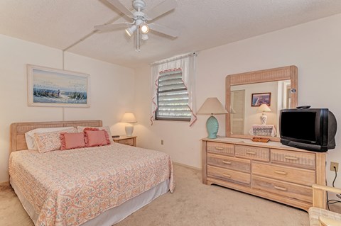 a bedroom with a bed and a tv