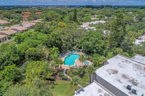 a birds eye view of a backyard with a pool and trees
