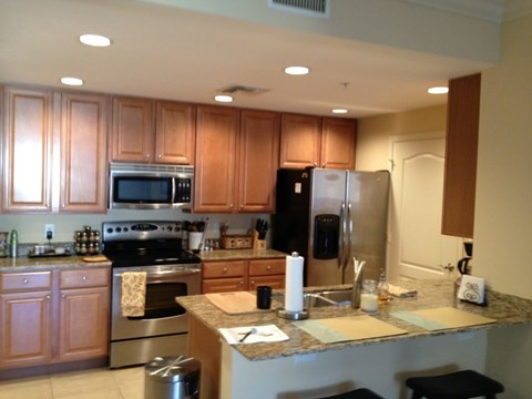 a kitchen with stainless steel appliances and wooden cabinets