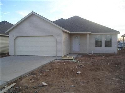 a white house with a driveway and a garage