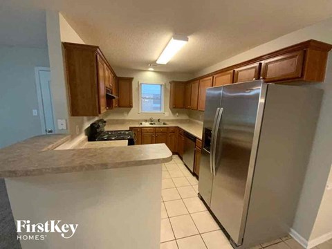 a kitchen with stainless steel appliances and wooden cabinets