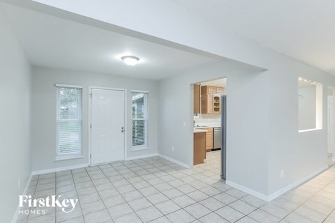 A white interior of a house with a kitchen in the background.