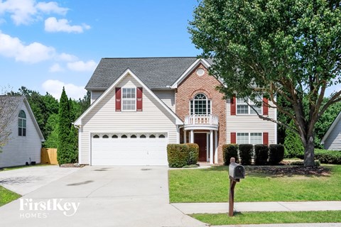 a house with a garage and a parking meter in front of it
