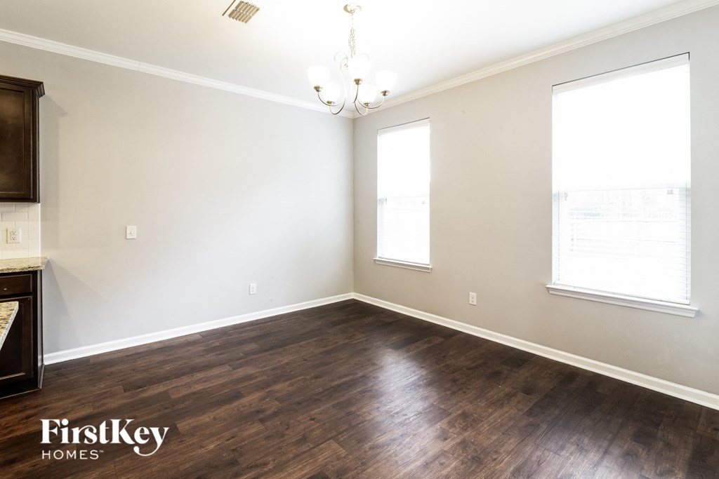 a living room with wood floors and white walls