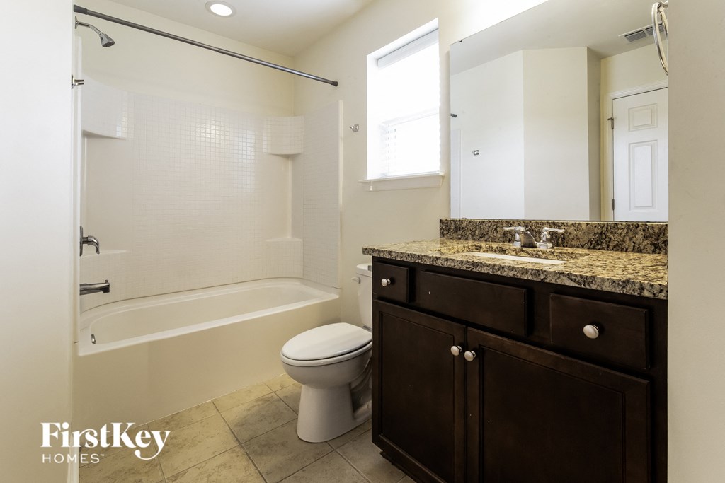 a bathroom with a toilet and a sink and a shower